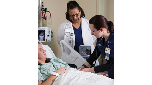 student and teacher with a patient